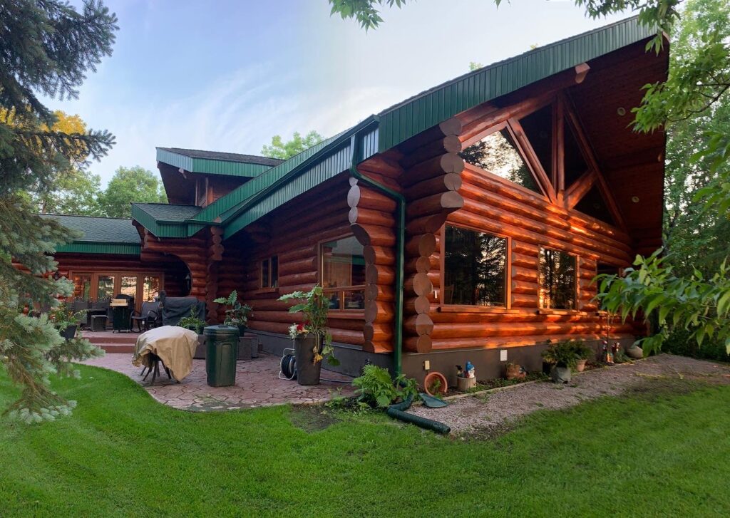 Exterior view of Ron’s Window Cleaning’s elegant log cabin surrounded by lush greenery